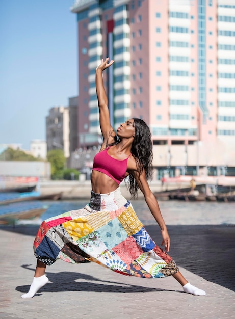 Side view of healthy woman standing on street in city