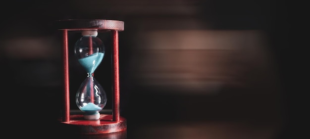 A side view of an hourglass with falling sand