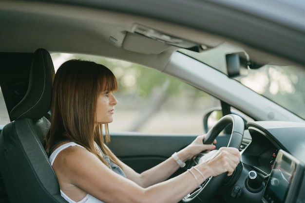 Side view of the interior of a car with a female driver