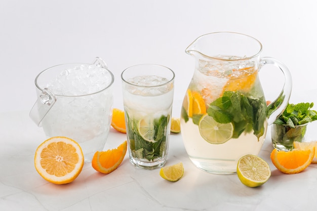 Side view on lemonade in a jug and glass 