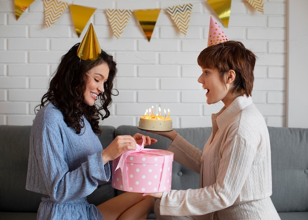 Side view lesbian couple celebrating birthday