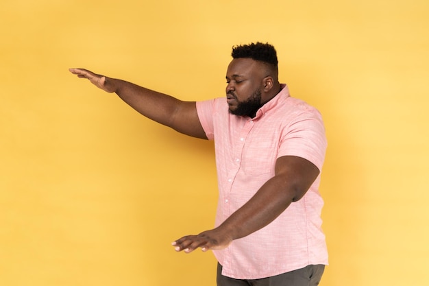 Side view of lonely blind disabled man standing with closed eyes outstretched hands searching way