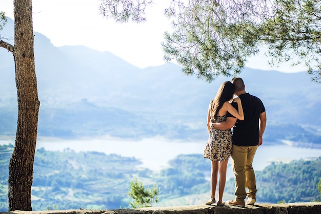 Side view of a loving young couple standing closely together