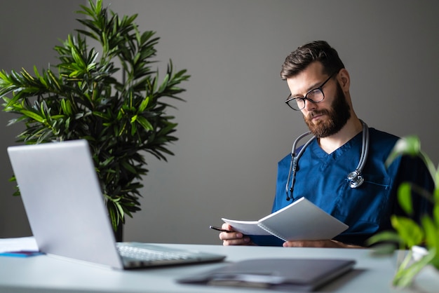 Side view male nurse at desk