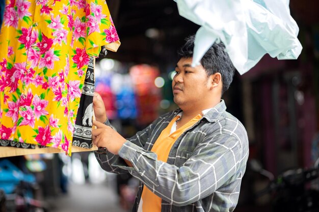 Side view of man choosing textile at store