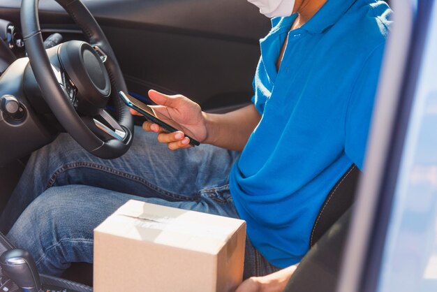 Photo side view of man holding camera while sitting in car