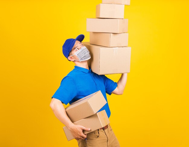 Side view of a man holding camera over yellow background