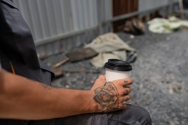 Side view man holding coffee cup