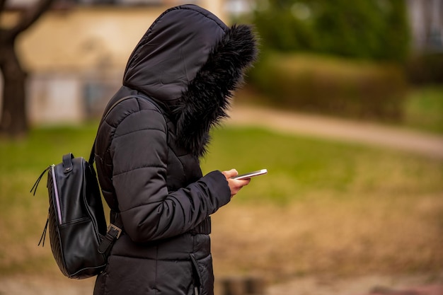 Side view of man holding mobile phone