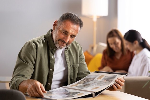 Side view man looking at picture album