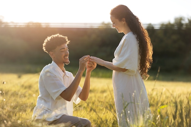 Side view man proposing with ring