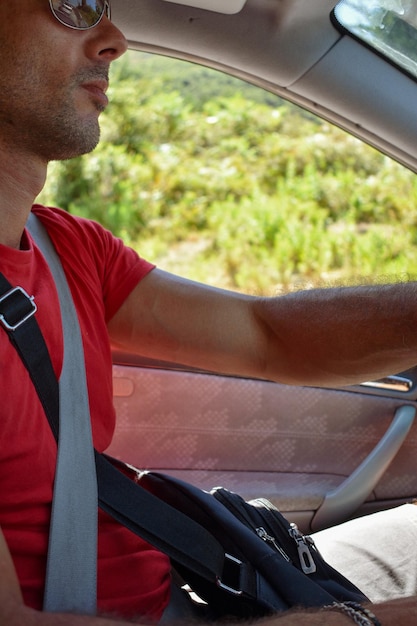 Side view of man sitting in car