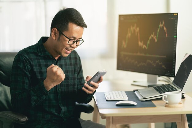 Side view of man using laptop at office