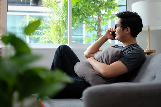 Side view of man using mobile phone at home