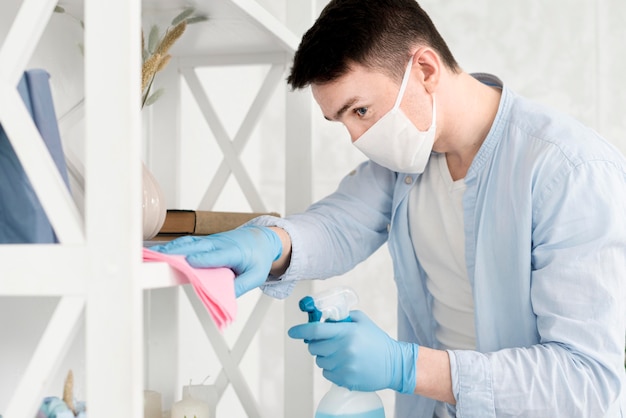 Side view of man with face mask cleaning