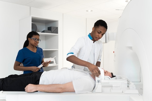 Side view man with headphones getting ct scan