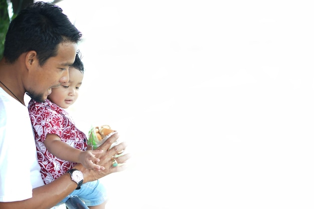 Side view of man with son standing outdoors