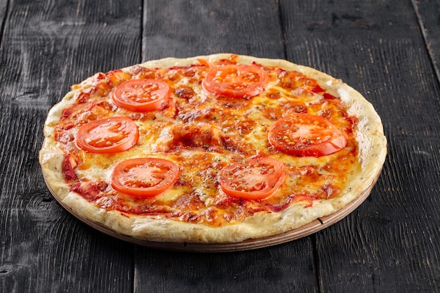 Side view on margherita pizza on wooden surface