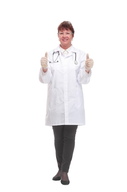 Side view of mature female doctor gives the thumbs up, isolated on white