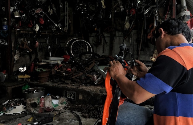 Side view of mechanic working at auto repair shop