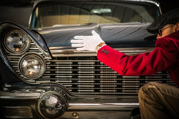 Side view of mid adult man repairing car in garage