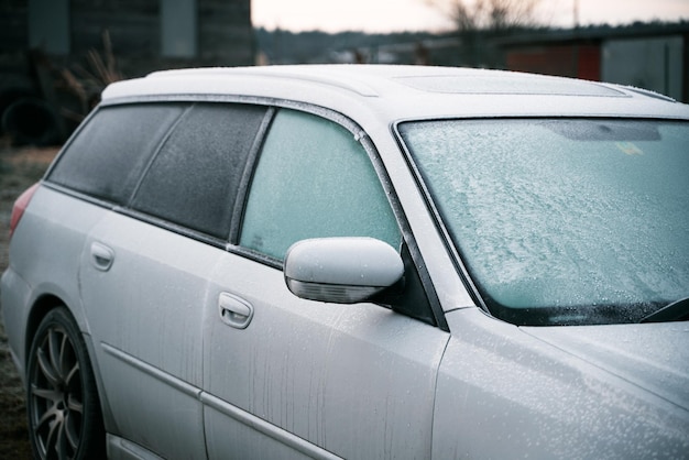 Side view mirror covered with hoarfrost frosty morning