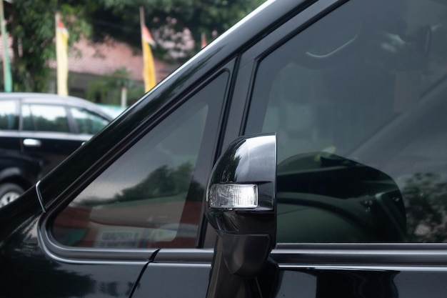 Side view mirror with turn signal lamp on a black car