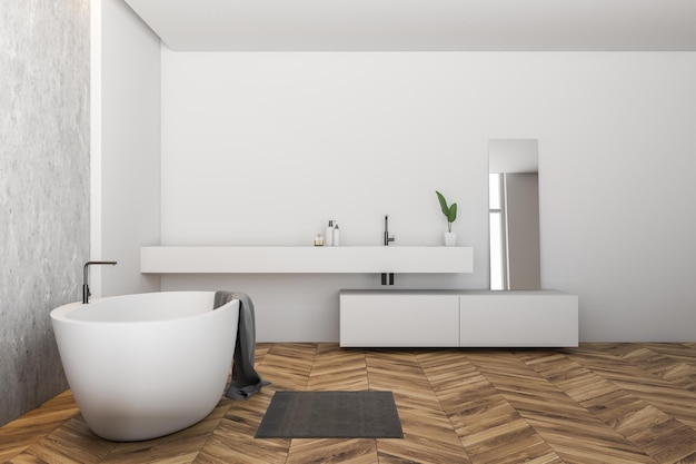 Side view of modern bathroom with white and concrete walls, wooden floor, white bathtub with towel on it and long white sink with mirror. 3d rendering