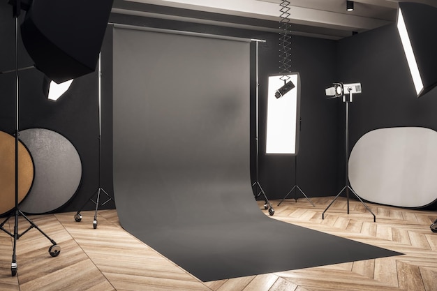 Photo side view of modern photo studio interior with black background professional equipment and wooden floor mock up 3d rendering