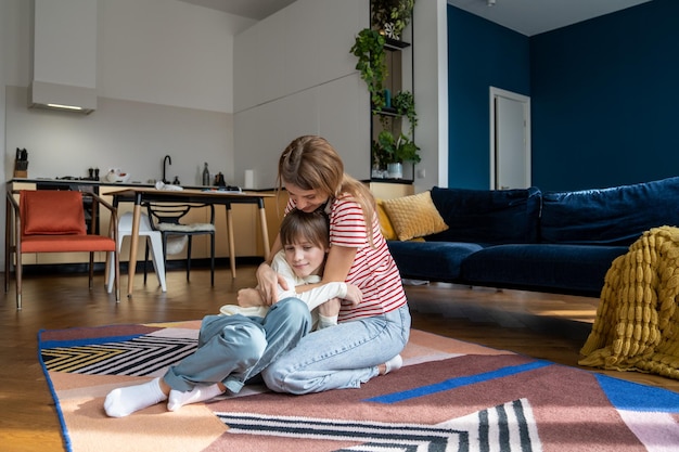 Side view of mother and daughter at home