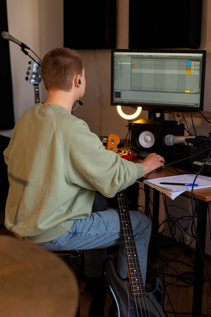 Photo side view musician working in studio