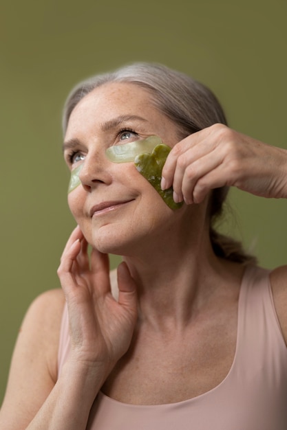 Side view old woman with eye patches