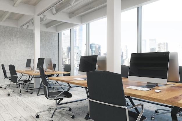 Side view of an open office interior with pillars, computers standing on wooden tables and panoramic windows. 3d rendering, mock up