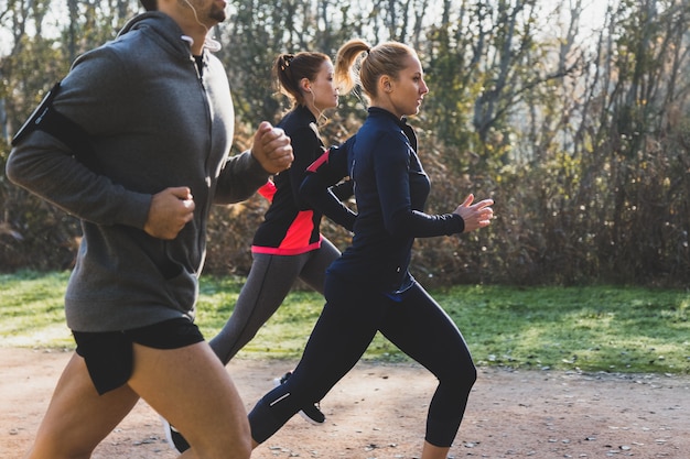 Side view of people running in the park