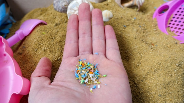 Side view of a person holding micro plastics in his hand Nonrecyclable materials