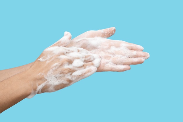Side view person using soap on blue background