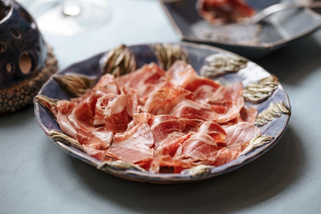 Side view on plate of spanish jamon appetizer