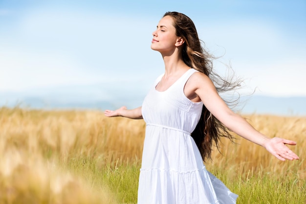 Side view portrait of a happy woman walking in a wheat field