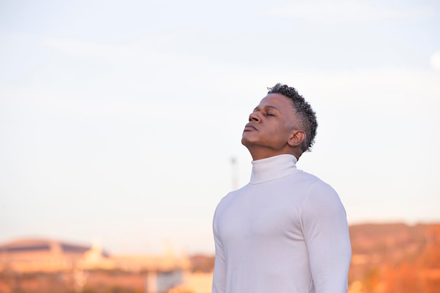 Side view portrait of a man breathing deep air in the city