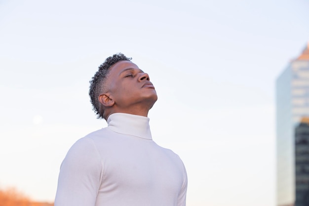 Side view portrait of a man breathing deep air at sunset