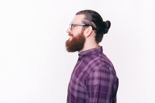 Side view portrait of young bearded man wearing eyeglasses