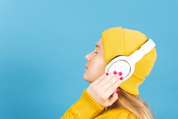 Side view of pretty young woman listening relaxing music