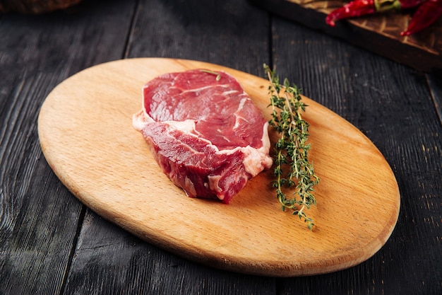 Side view on raw piece of meat with rosemary