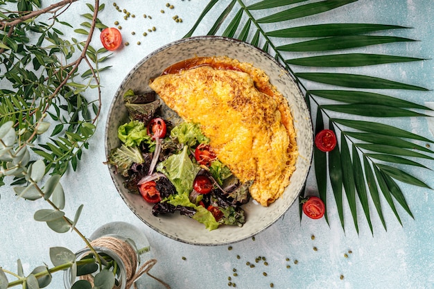 Side view on rustic omelette with vegetables salad