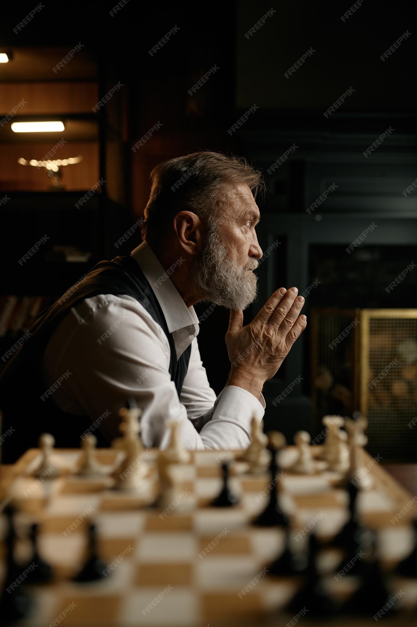 Senior man thinking about his next move in a game of chess Stock Photo by  dmytros9