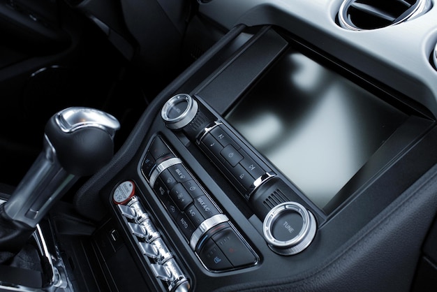Photo side view of shifter of automatic transmission and head monitor inside the vehicle