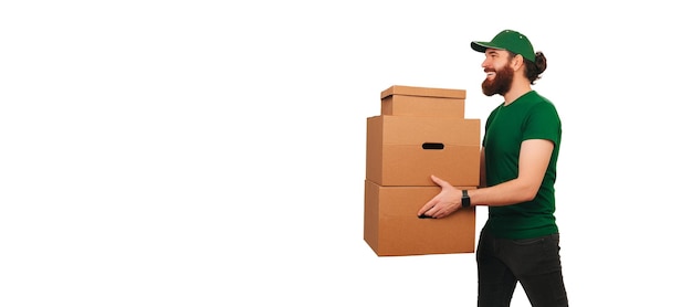 Side view shot of a powerful delivery man holding up some boxes while at work