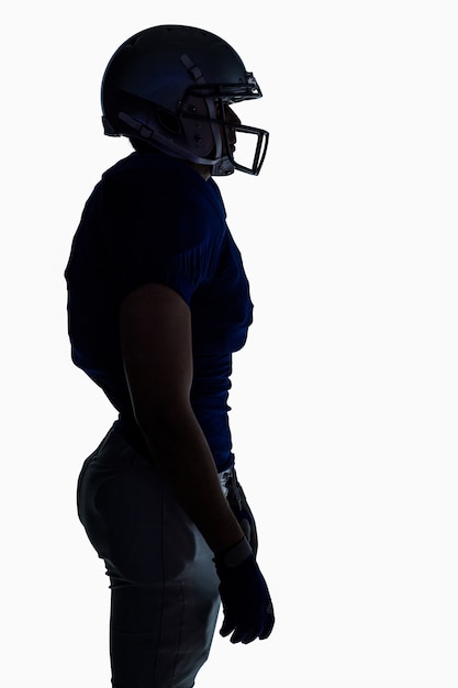 Side view of silhouette American football player standing