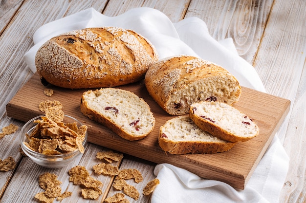 Side view on sliced muesli cereal bread on the wooden cutting board