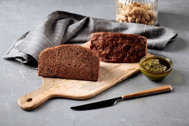 Photo side view on sliced triangle flourless diet grain bread on cutting board